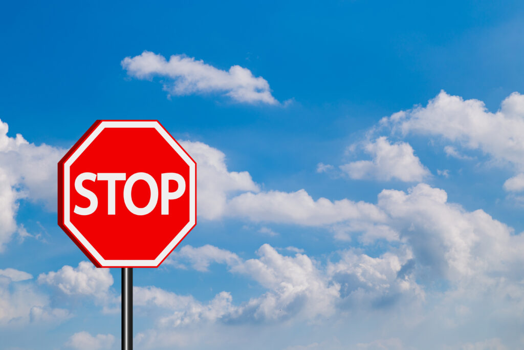 Stop sign in blue sky